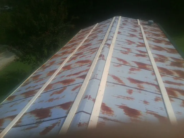 Rusted metal roof panels with new wood purlins before replacement — Storm Damage Roof Repair in Hood River by Roofing Brothers